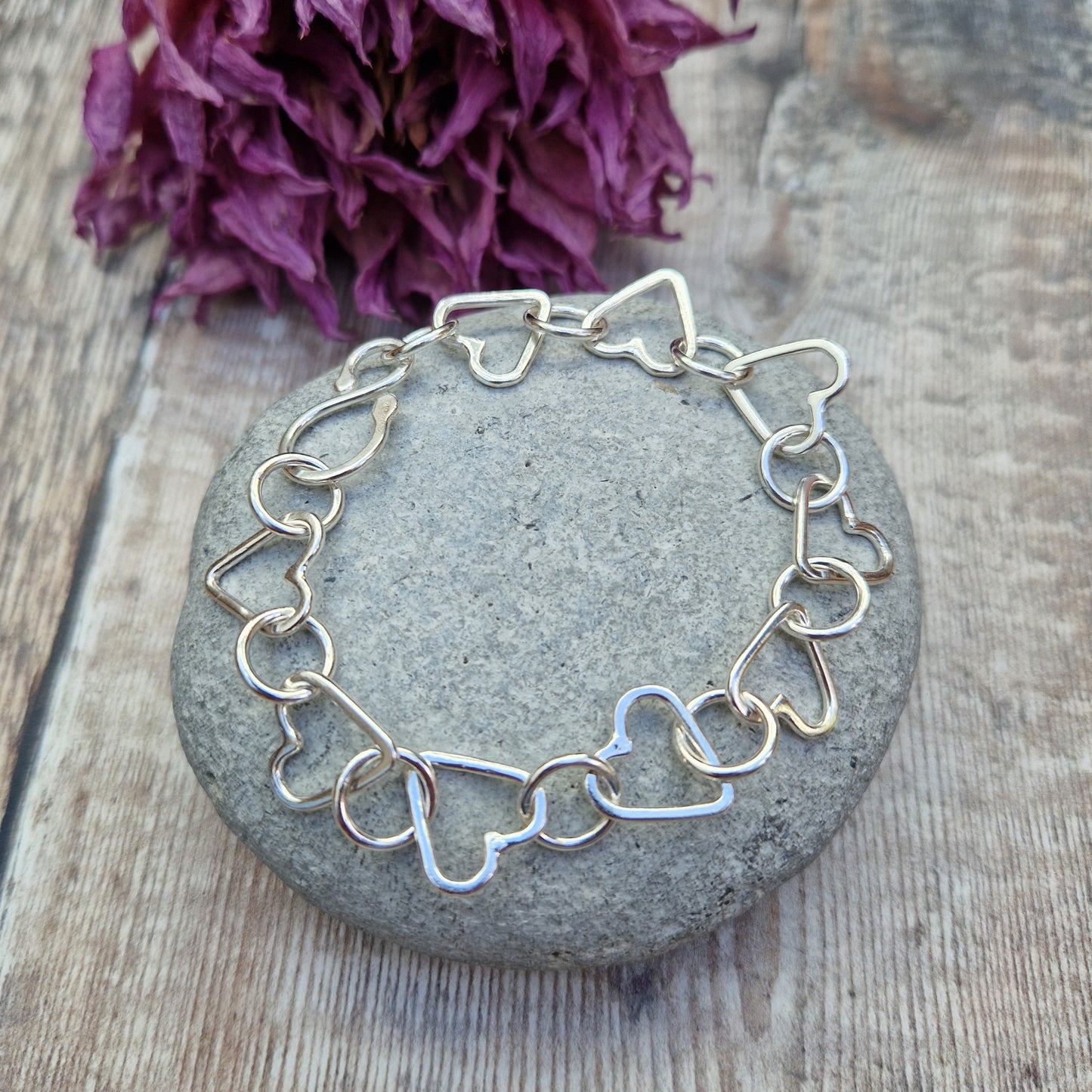 Sterling Silver interlinking hearts bracelet. Each open heart is linked with an open circle, nine hearts and 10 circles in total repeating pattern with ‘S’ link.