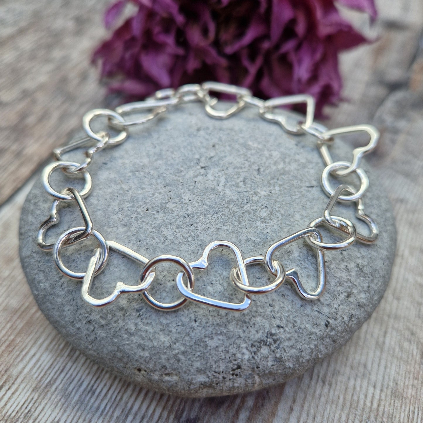 Sterling Silver interlinking hearts bracelet. Each open heart is linked with an open circle, nine hearts and 10 circles in total repeating pattern with ‘S’ link.