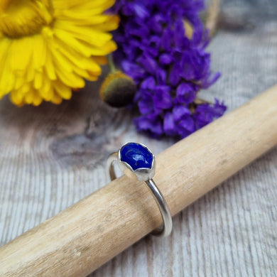 Sterling Silver Lapis Lazuli Blue Gemstone Ring, UK Size R. Royal blue coloured stone, oval shape with slight diamond hammered texture, set in a delicate scalloped edge silver surround, placed lengthwise on top of ring. Stone measures approximately 6mm x 8 mm. Ring band is approx. 2 mm wide.