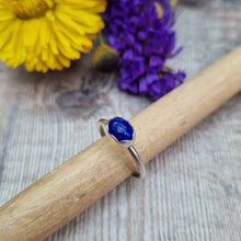 Load image into Gallery viewer, Sterling Silver Lapis Lazuli Blue Gemstone Ring, UK Size R. Royal blue coloured stone, oval shape with slight diamond hammered texture, set in a delicate scalloped edge silver surround, placed lengthwise on top of ring. Stone measures approximately 6mm x 8 mm. Ring band is approx. 2 mm wide.