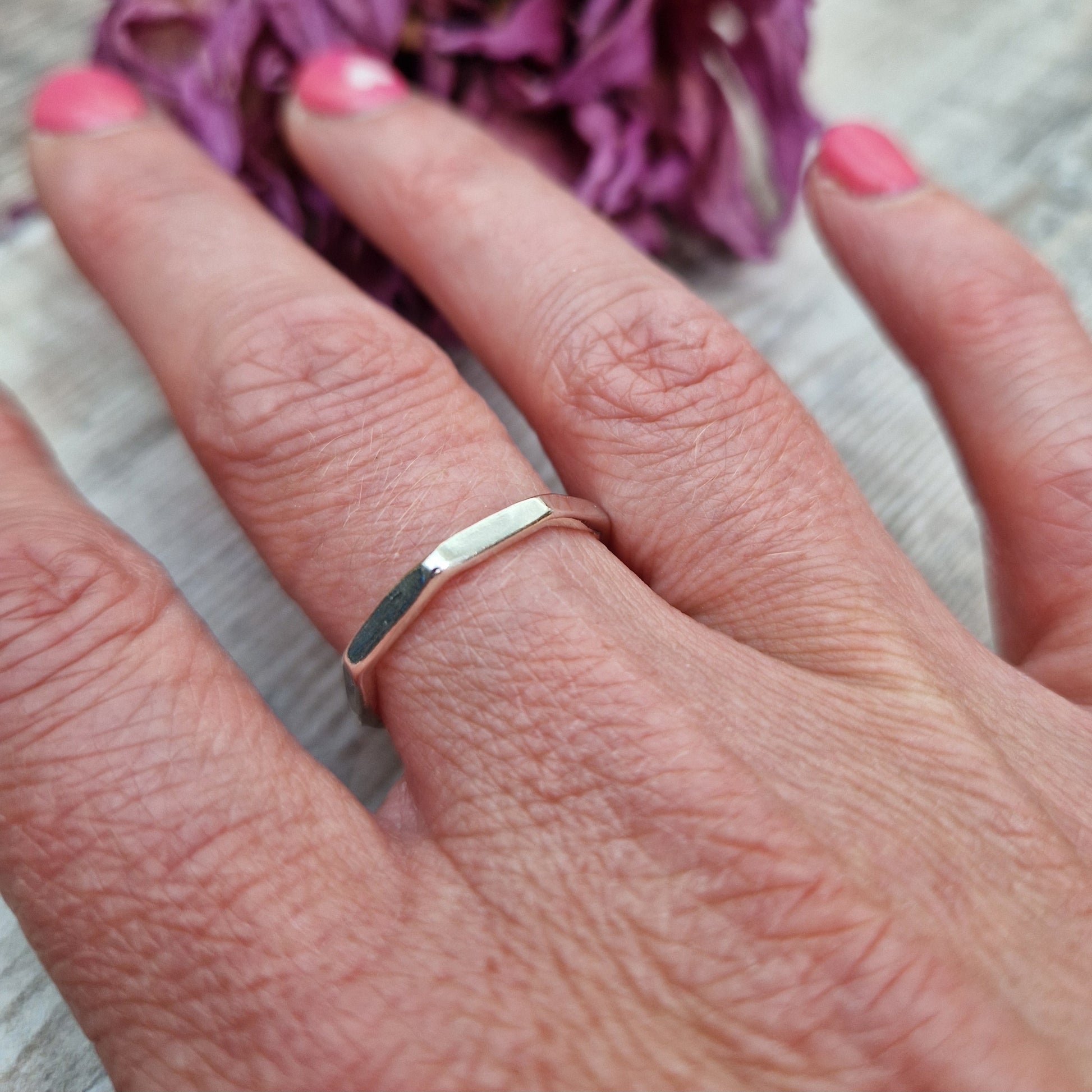 Sterling Silver octagonal shaped ring with flat sides on each edge of the octagon shape.