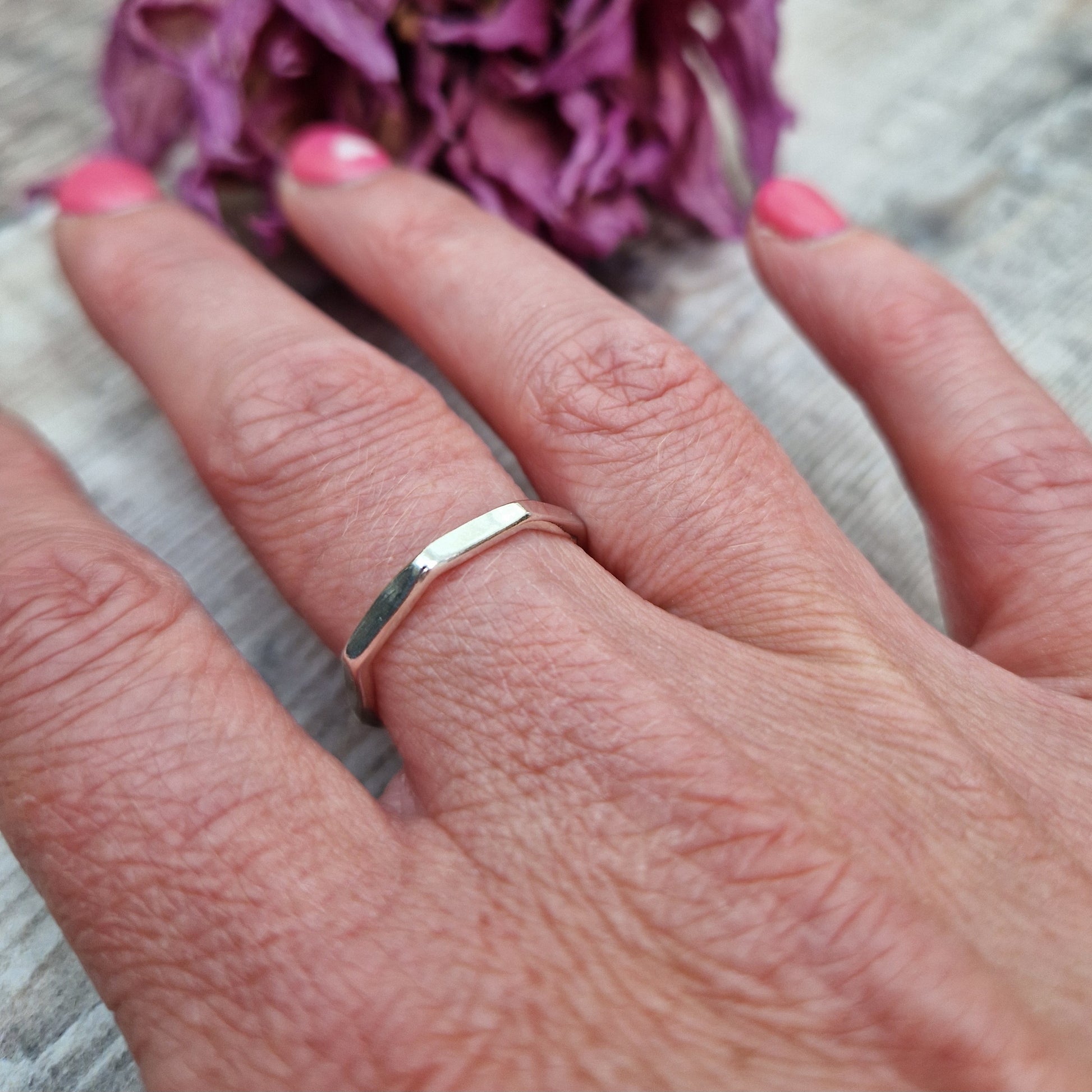 Sterling Silver octagonal shaped ring with flat sides on each edge of the octagon shape.