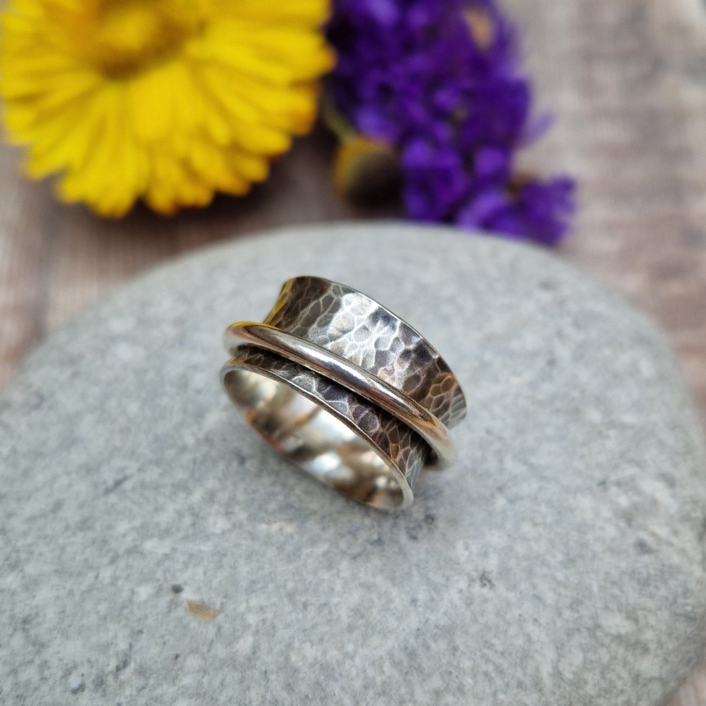 Wide oxidised Sterling Silver band with hammered texture finish with additional 2mm wide silver band around the middle that spins independently.