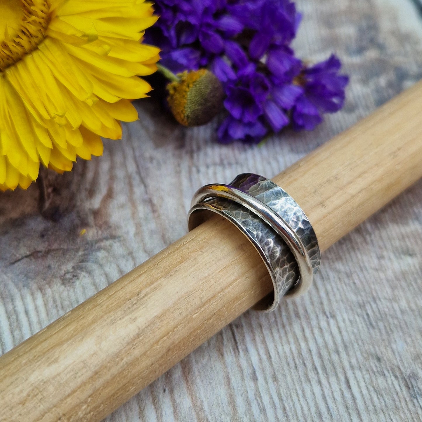 Wide oxidised Sterling Silver band with hammered texture finish with additional 2mm wide silver band around the middle that spins independently.