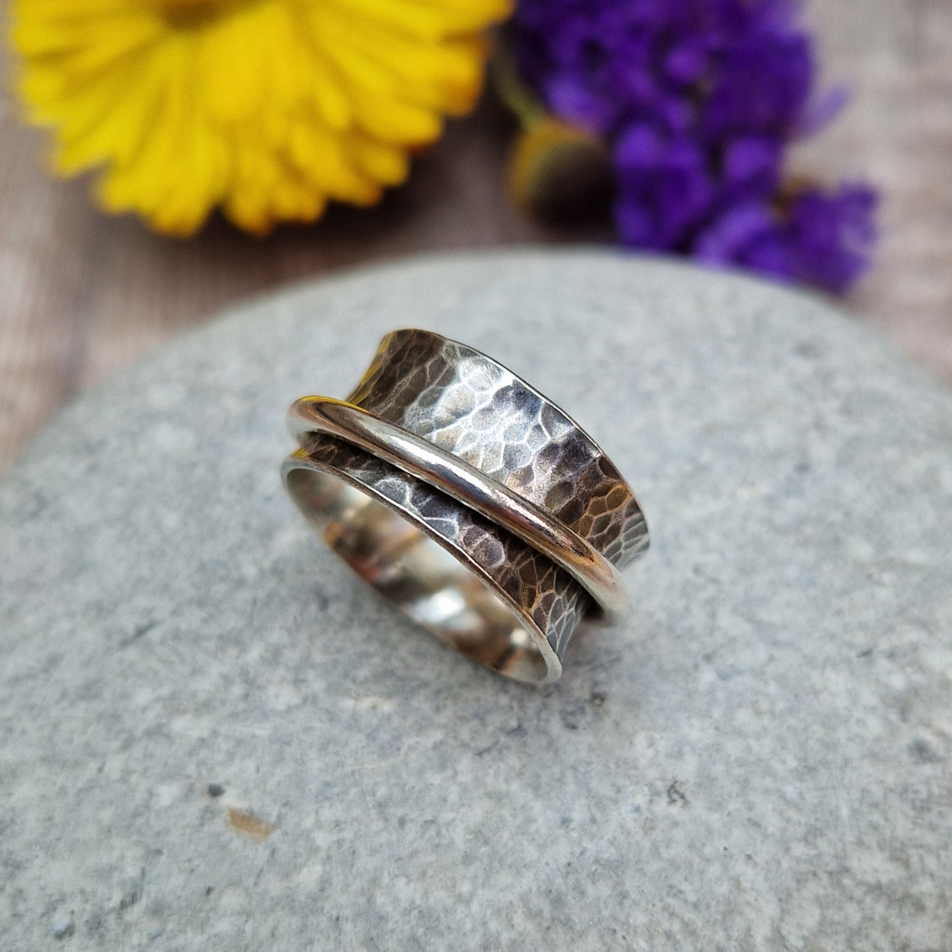 Wide oxidised Sterling Silver band with hammered texture finish with additional 2mm wide silver band around the middle that spins independently.