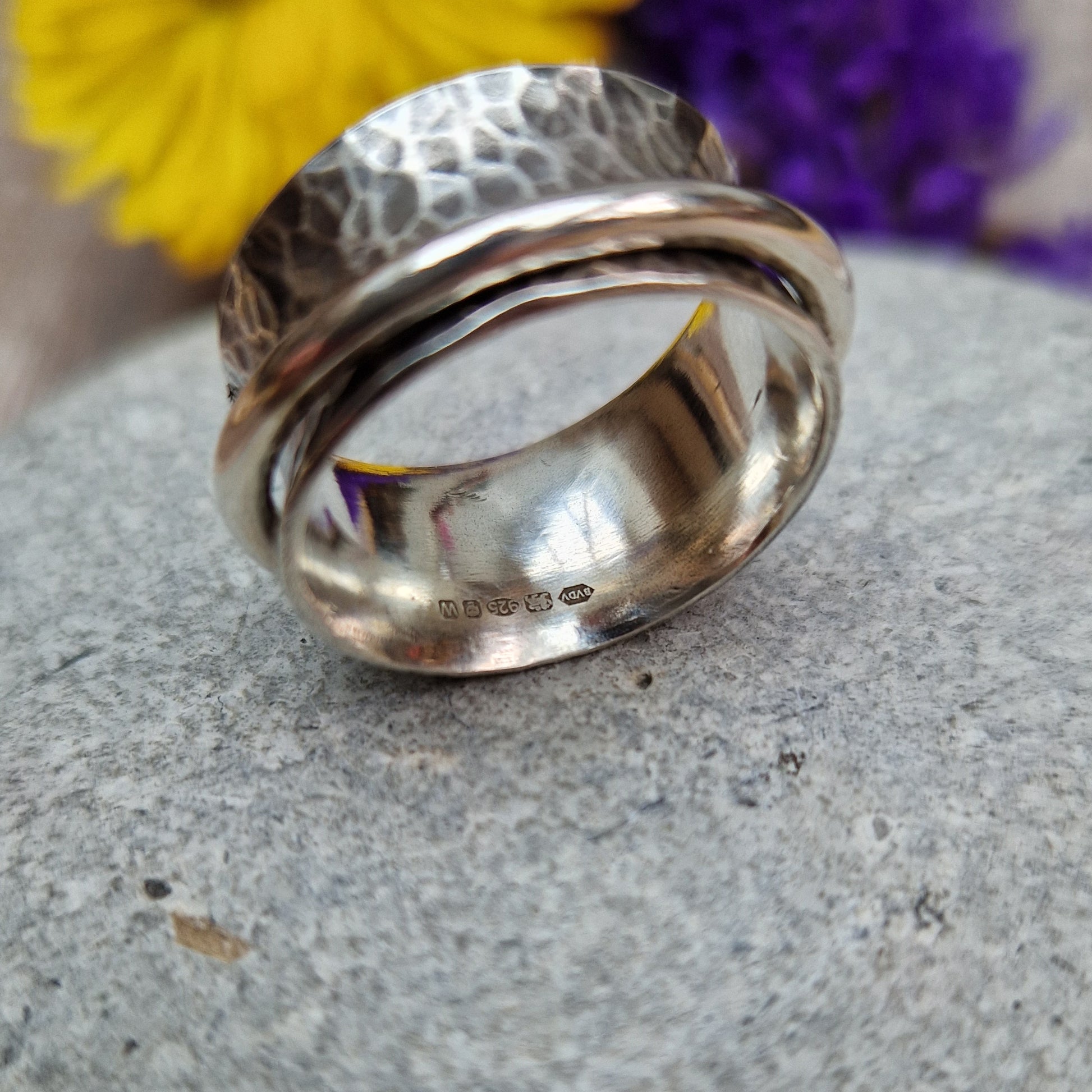 Wide oxidised Sterling Silver band with hammered texture finish with additional 2mm wide silver band around the middle that spins independently.