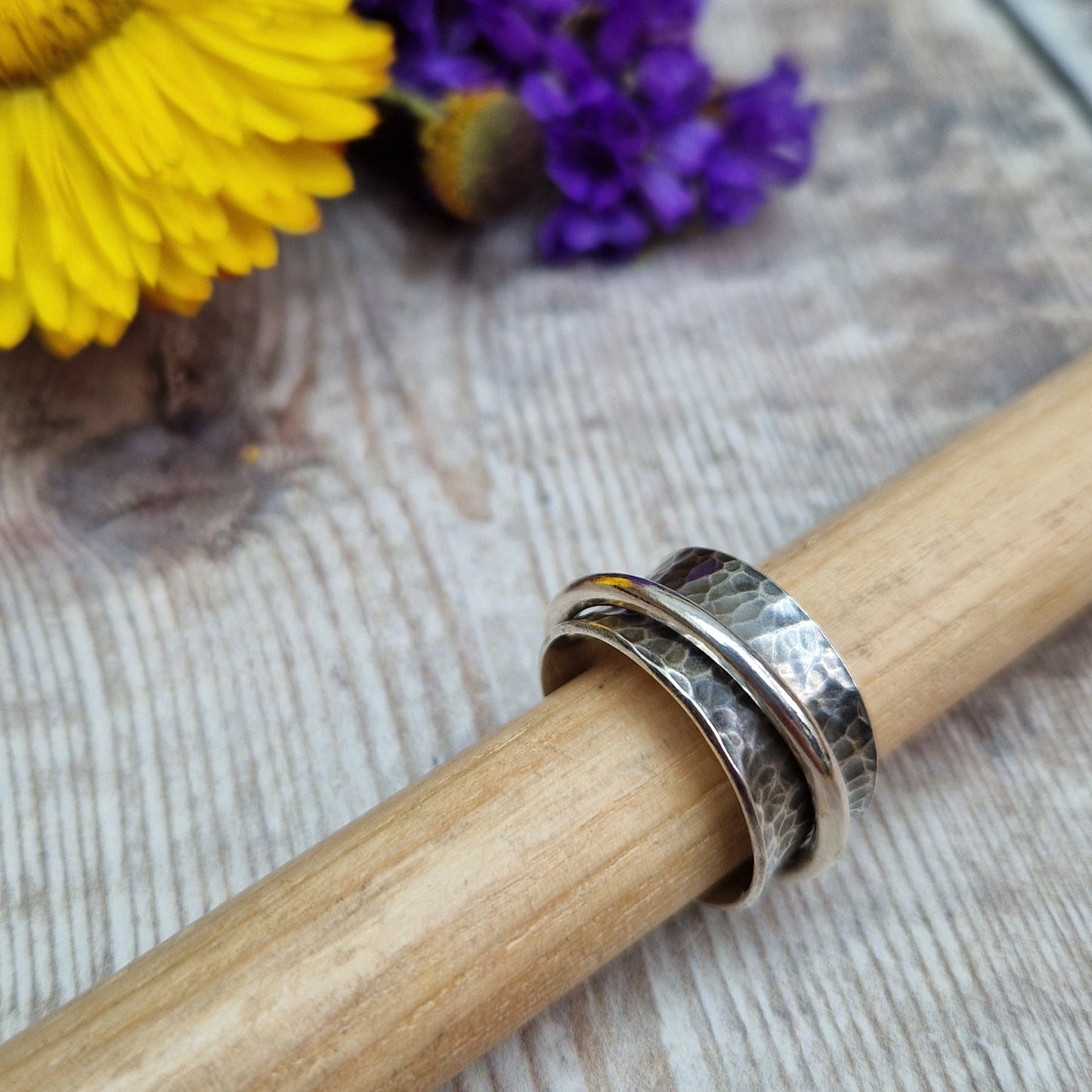 Wide oxidised Sterling Silver band with hammered texture finish with additional 2mm wide silver band around the middle that spins independently.