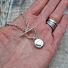 Load image into Gallery viewer, Sterling Silver Pebble Heart Necklace Displayed on Hand to Show Size