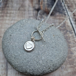Sterling Silver Pebble Necklace Displayed on a Grey Pebble