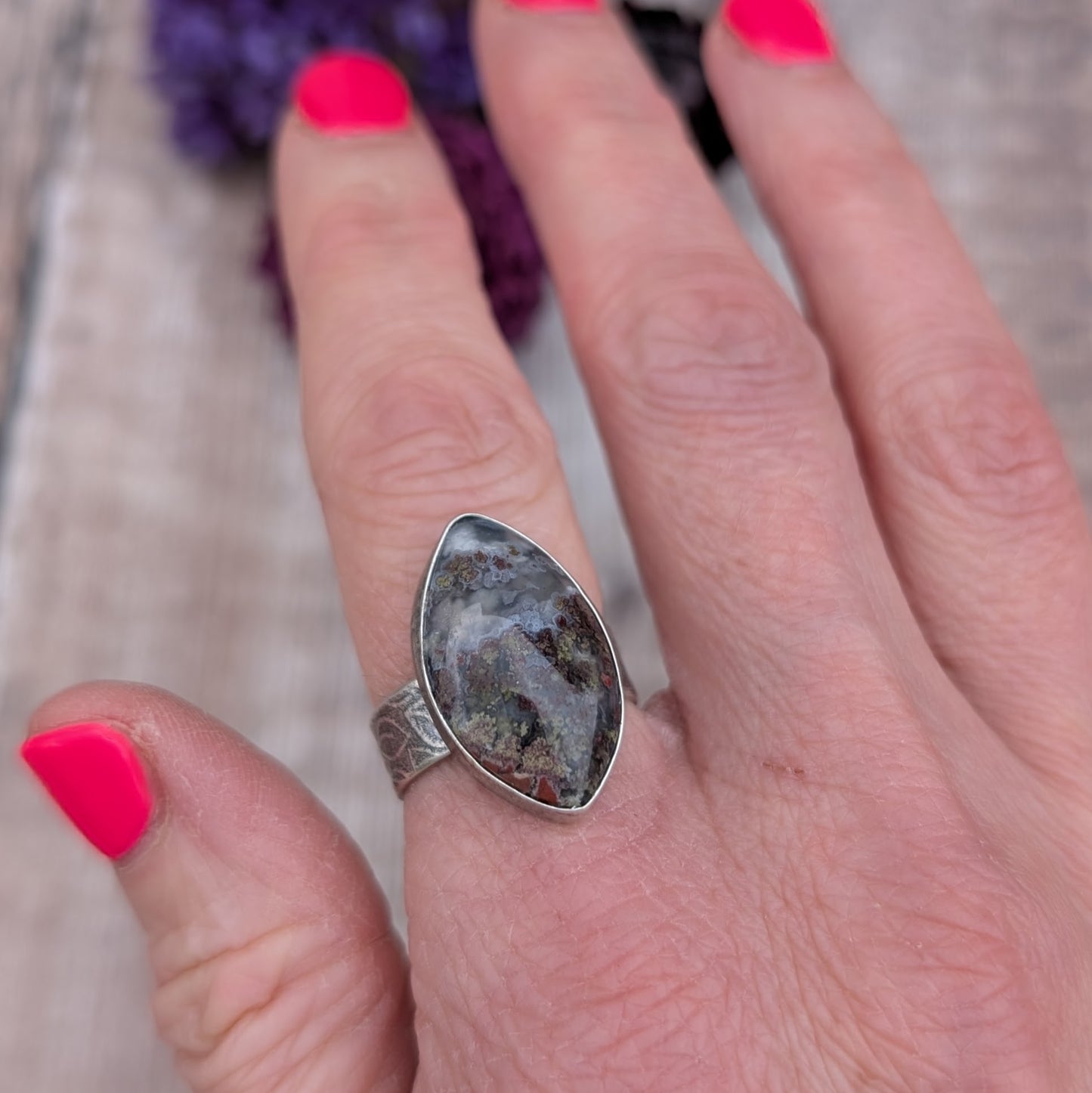 Silver Plume Agate Ring on finger with bright pink nails, highlighting the unique natural patterns in the plume agate stone