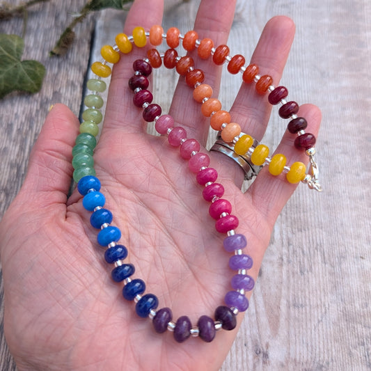 Rainbow Jade Bead Necklace held in a hand, displaying the full range of colourful jade beads and recycled Sterling Silver spacers and clasp.