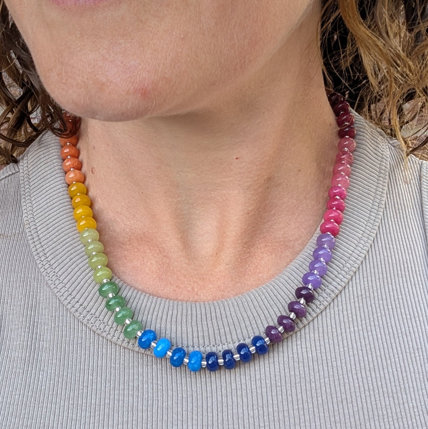 Rainbow Jade Bead Necklace worn around the neck, featuring colourful jade beads arranged in a rainbow pattern with recycled Sterling Silver details.