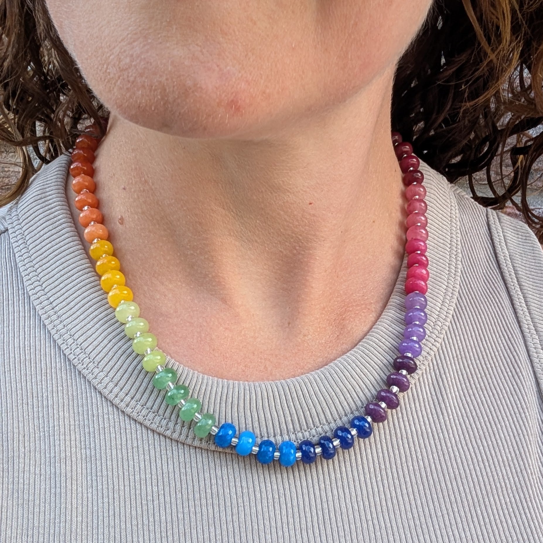 Rainbow Jade Bead Necklace worn with a grey top, showing the colourful jade bead design and recycled Sterling Silver details.