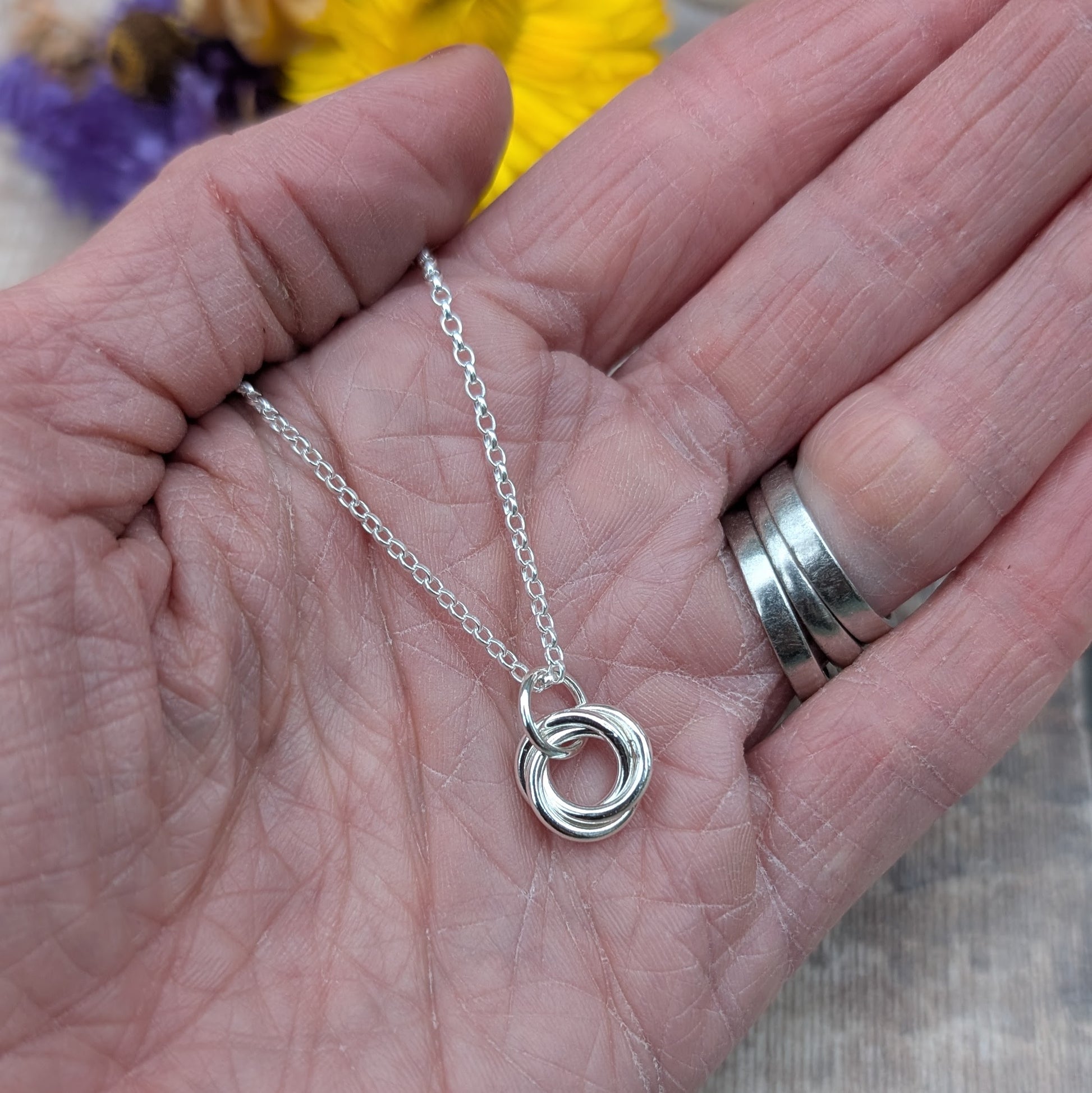 Sterling Silver three linked Russian Ring necklace. Three open circles, approx. 12mm diameter, linked together as a Russian Ring (rings entwined). Suspended from a silver chain via silver open circle link.