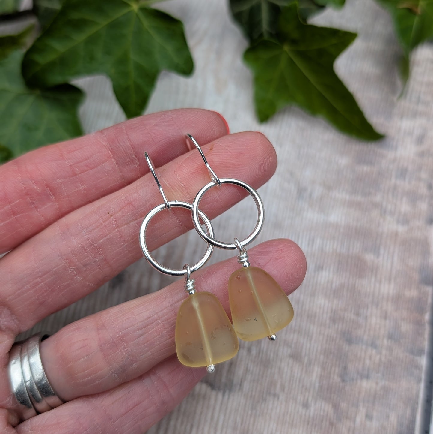 Pair of handmade Silver Circle Earrings with Yellow Sea Glass Beads made from recycled Sterling Silver.