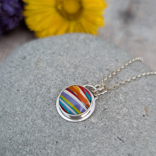 Close-up of Silver Colourful Small Round Surfite Necklace highlighting colourful Surfite stripes and silver setting
