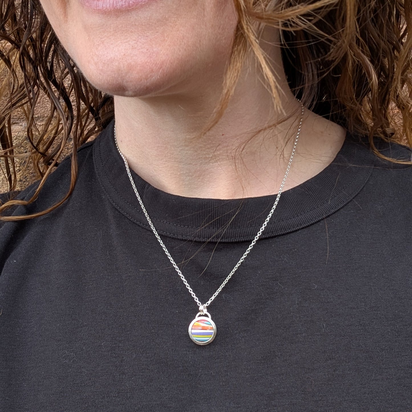 Silver Colourful Small Round Surfite Necklace worn on a person with a black top