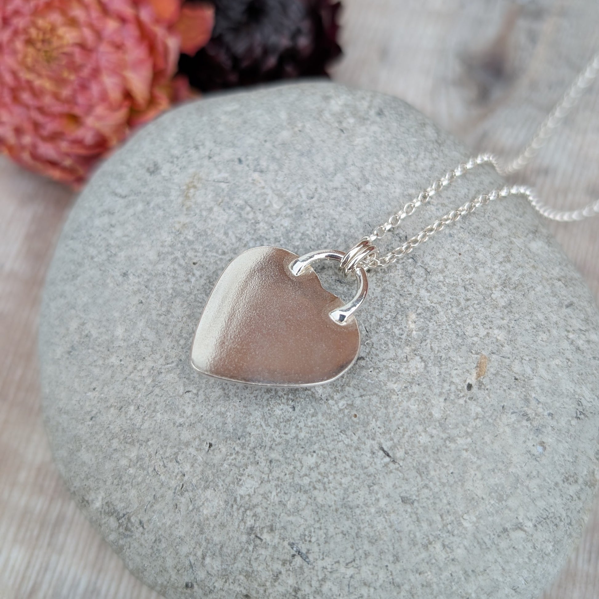 Back of silver heart necklace showing smooth polished sterling silver reverse and chain detail.