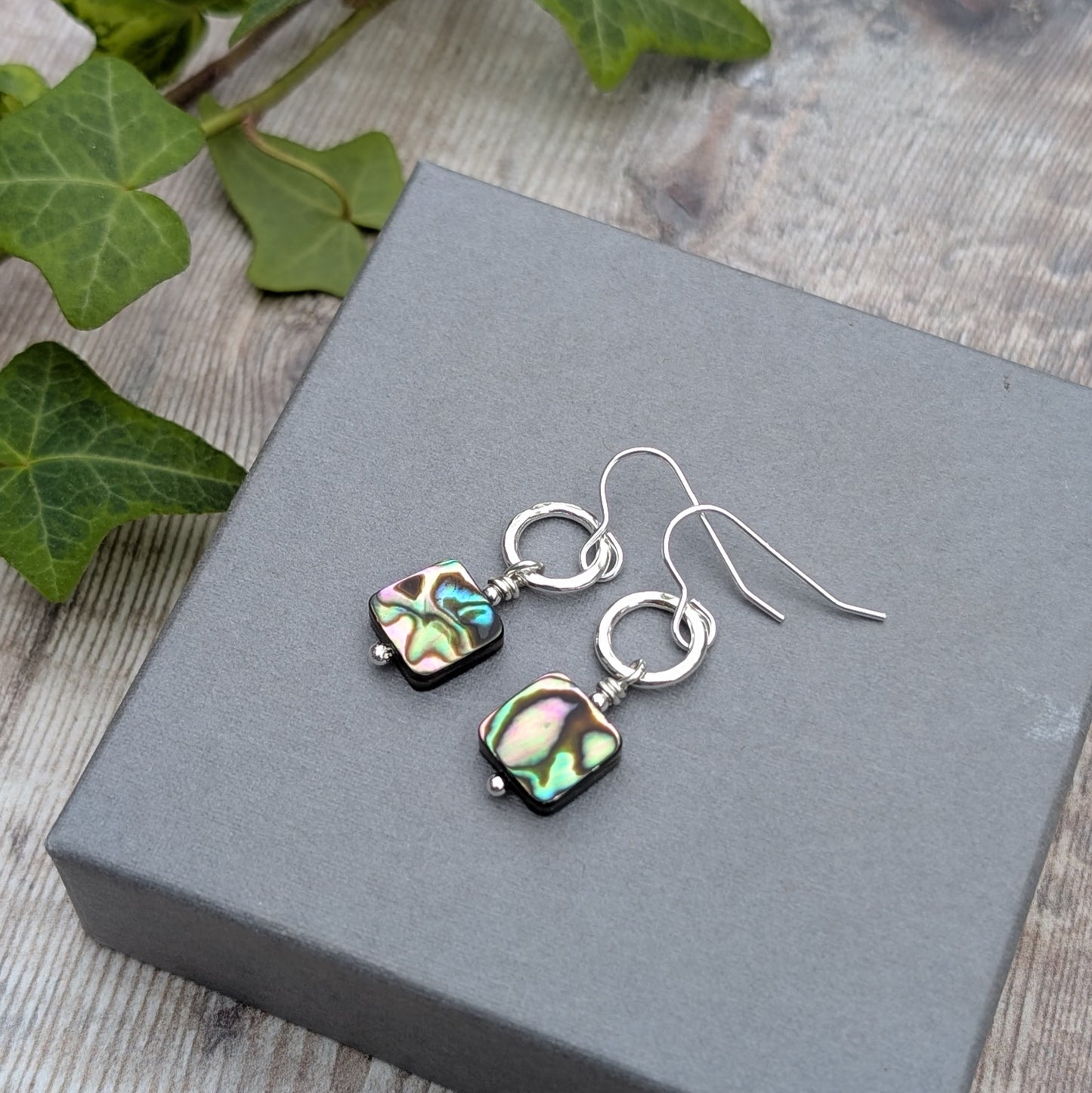 Close-up of Silver Hammered Circle Earrings with Abalone Shell Beads showing colourful natural shell patterns