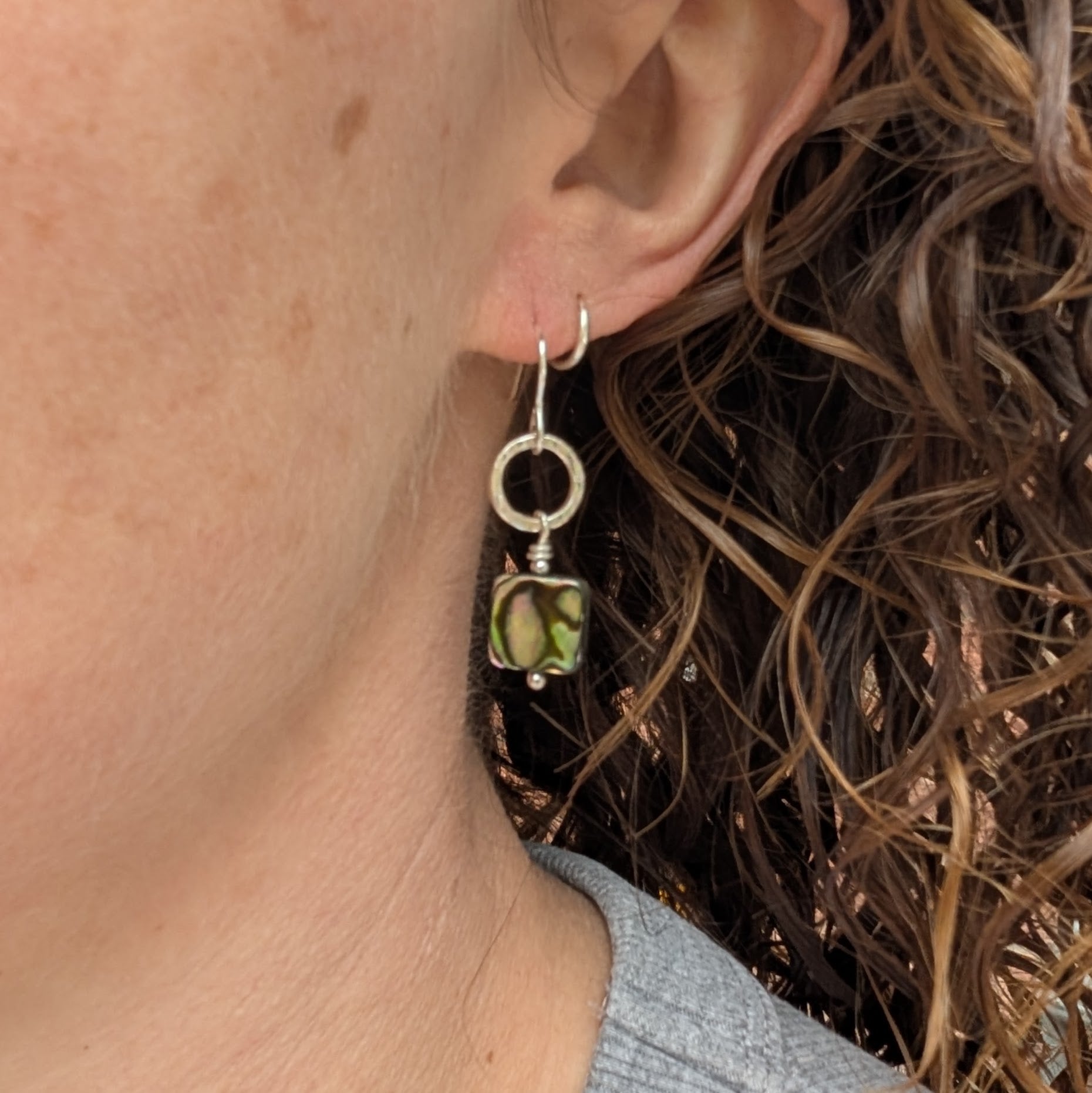 Silver Hammered Circle Earrings with Abalone Shell Beads worn on ear showing drop length and fit
