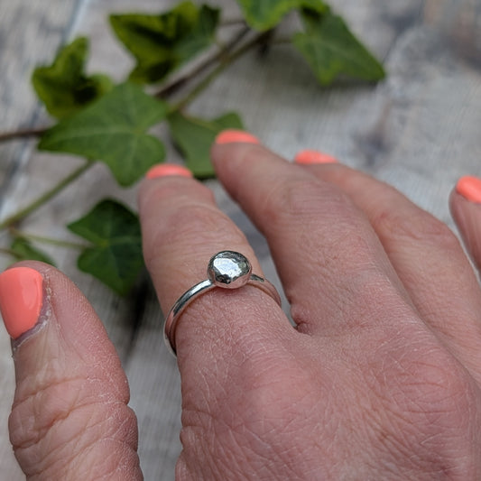 Silver Hammered Pebble Ring worn on a hand, showing the small hammered silver pebble detail