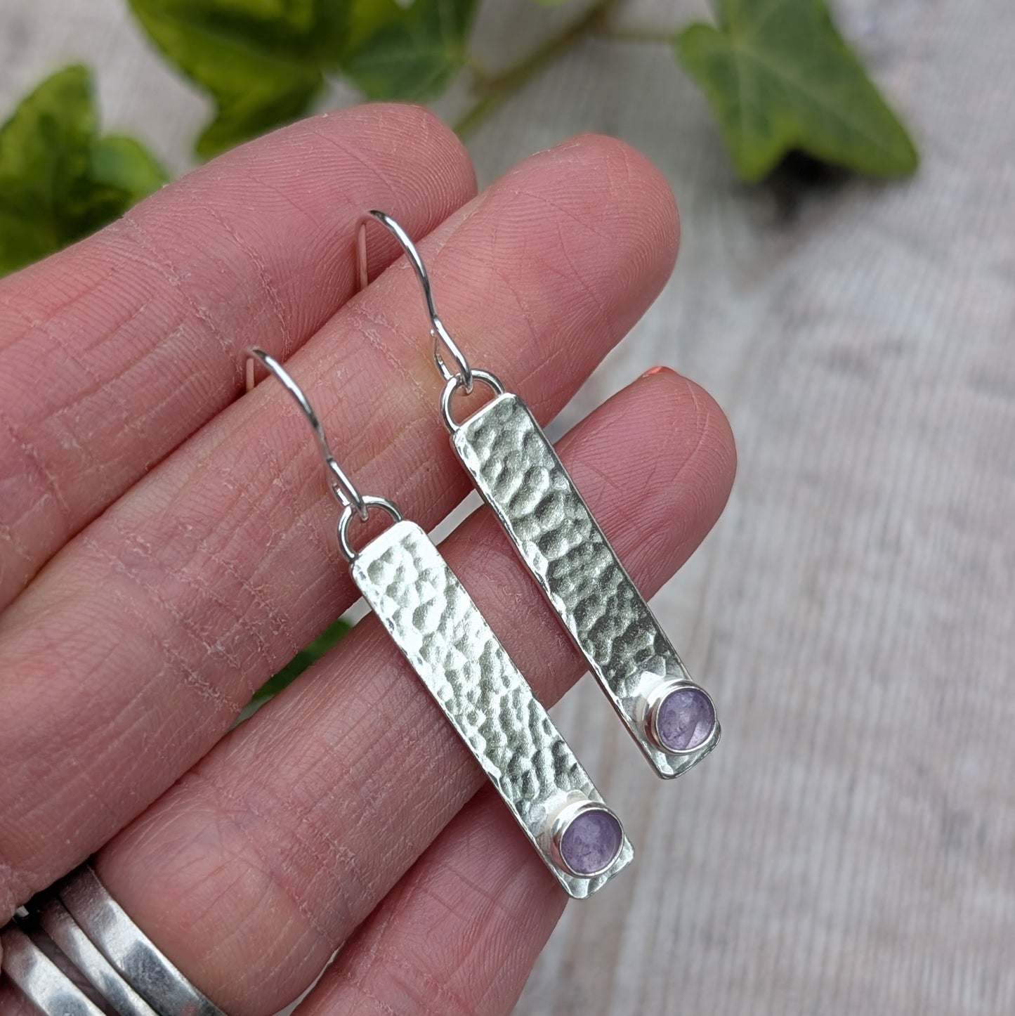 Silver Hammered Rectangle Earrings with Lavender Amethyst displayed in hand with natural light highlighting texture