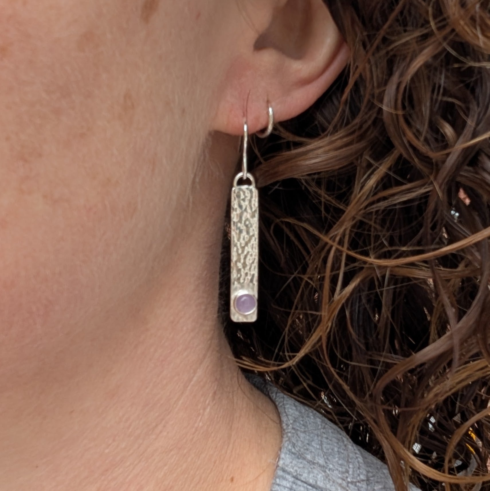 Silver Hammered Rectangle Earrings with Lavender Amethyst worn on ear showing length and fit