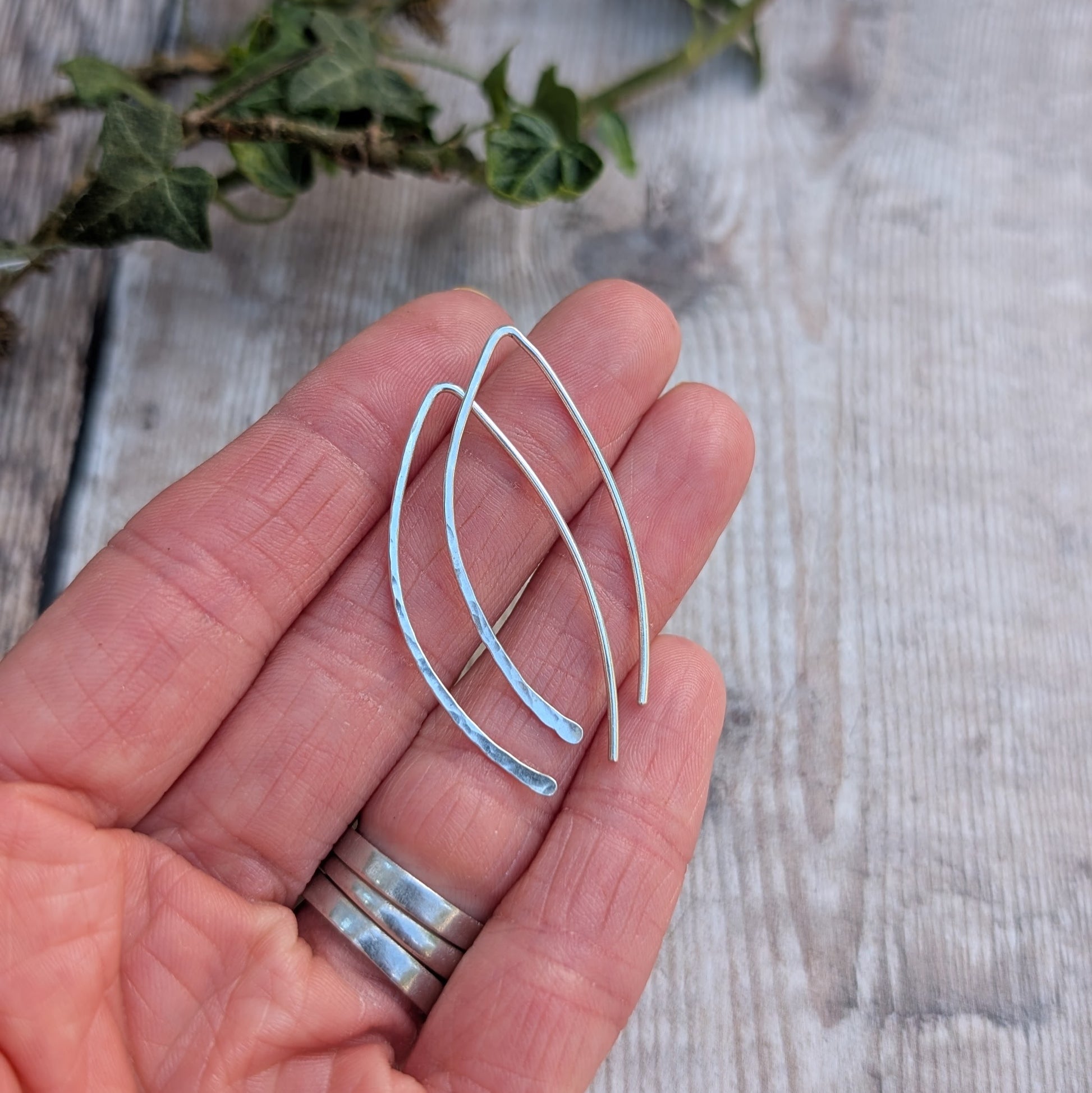 Silver Large Threader Earrings handmade from recycled sterling silver, resting in a hand to show their size and lightly hammered detail.