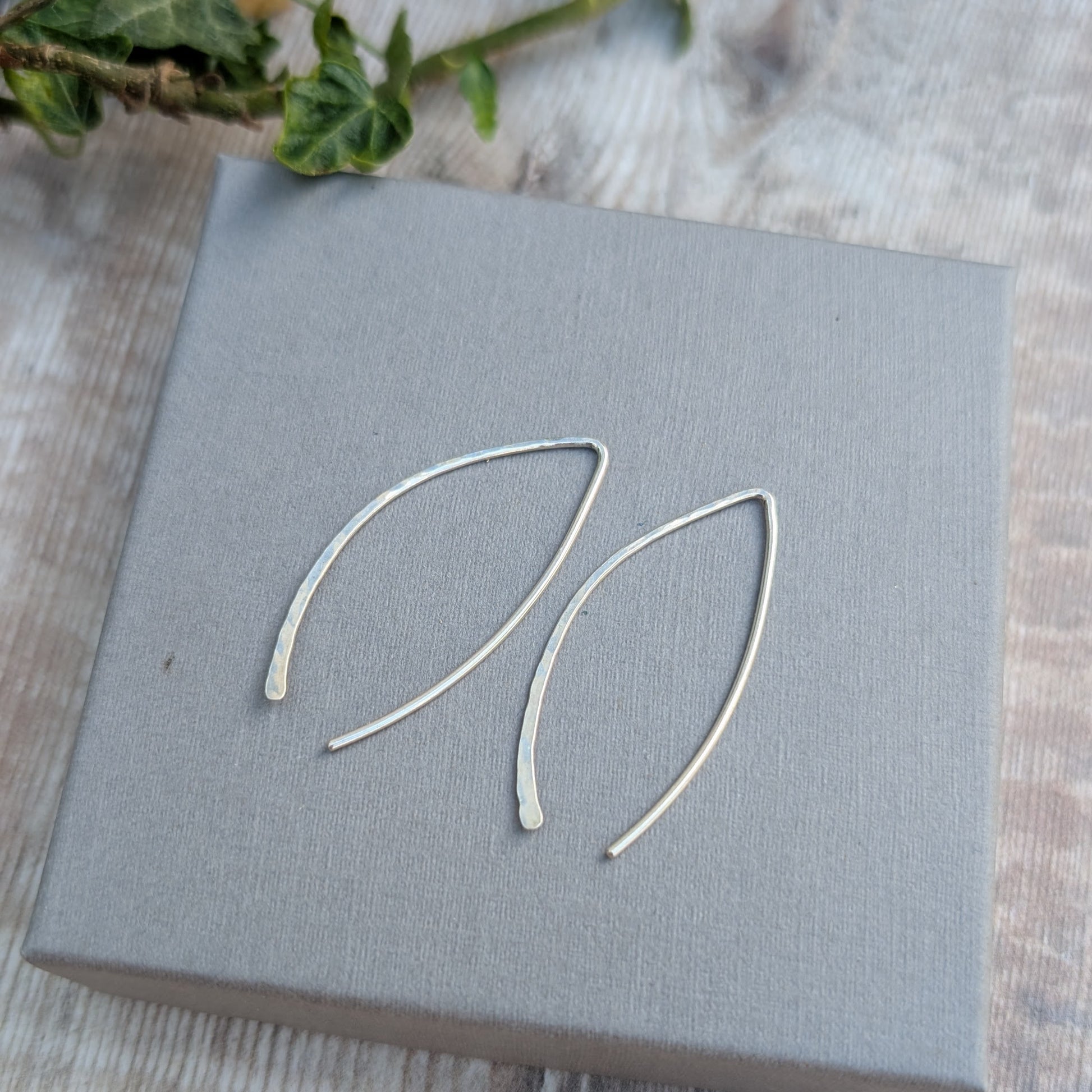 Silver Large Threader Earrings made from recycled sterling silver, shown on a grey jewellery box with ivy leaves in the background.