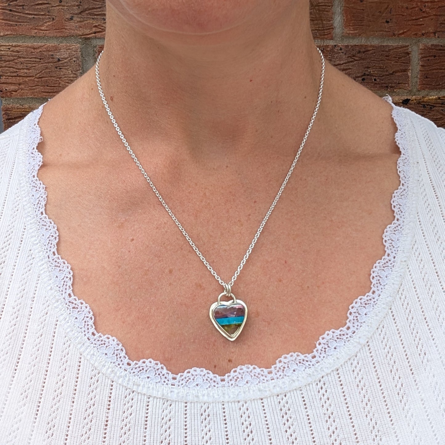 Silver Multicoloured Surfite Heart Necklace being worn, showing the size and length of the colourful heart pendant.
