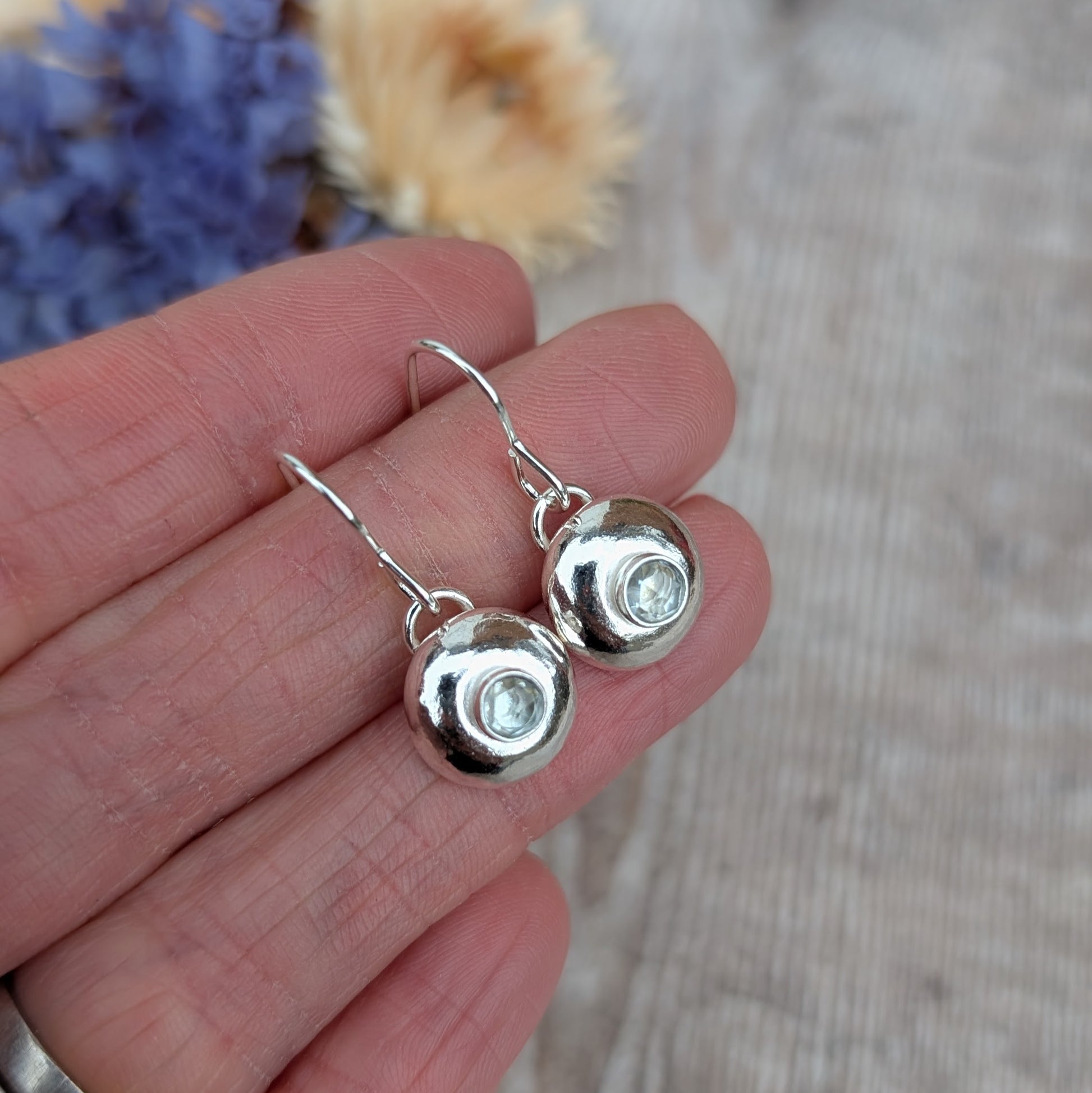 Silver pebble earrings with Aquamarine showing the small rose cut stones.