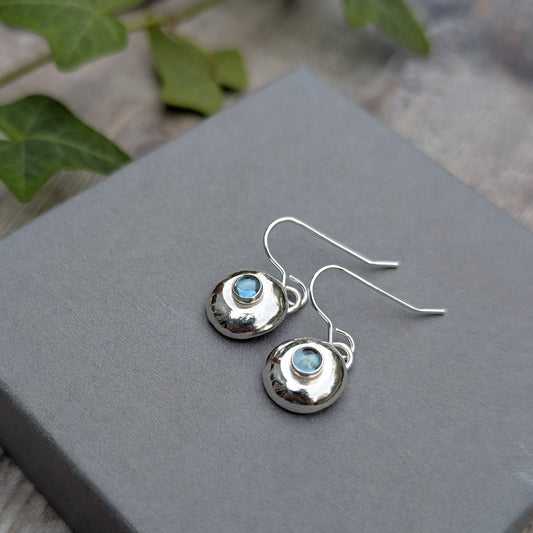 Silver Pebble Earrings with Blue Topaz displayed on a jewellery box with simple hook wires
