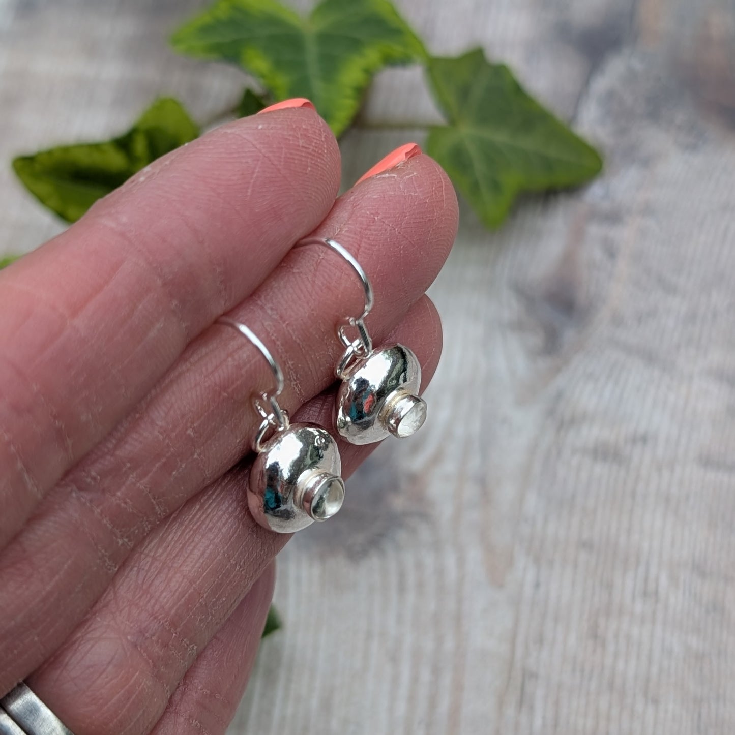 Side view of Silver Pebble Earrings with Crystal Quartz showing the raised handmade stone setting