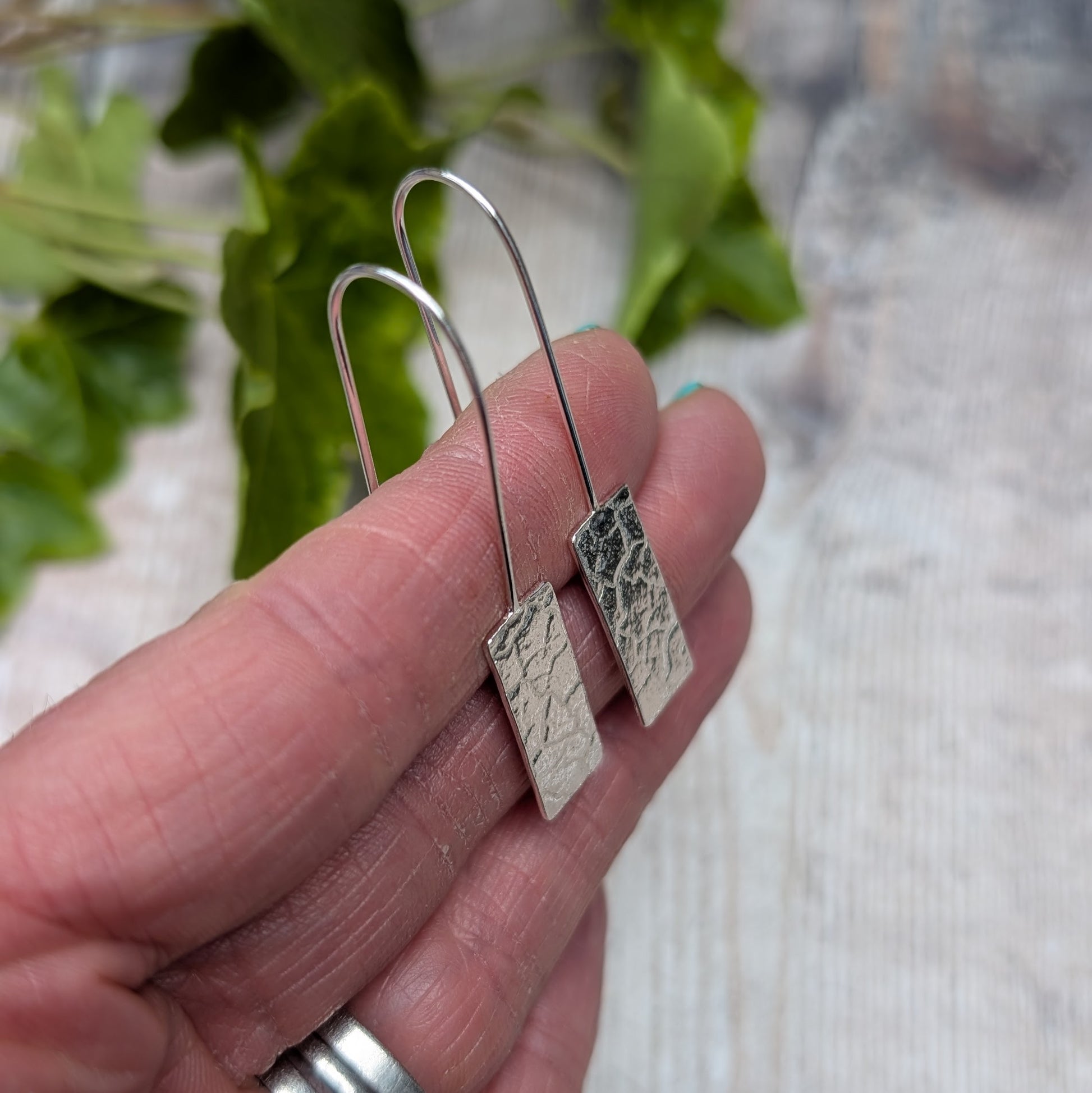 Side view of Silver Rectangle Earrings with Cracked Earth Pattern showing slim profile and hook shape