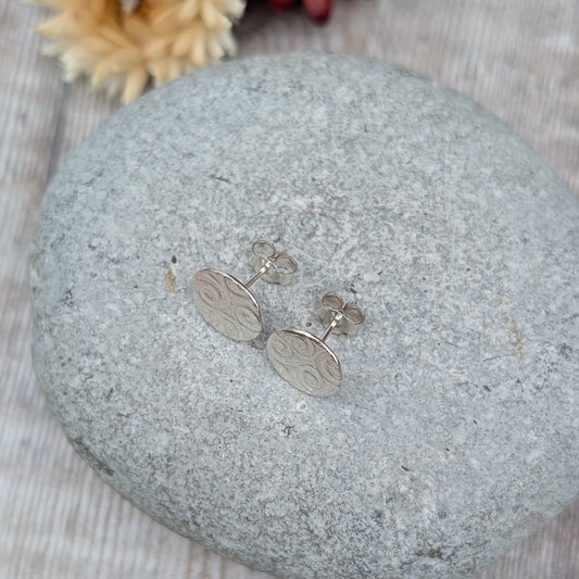 Silver Spiral Pattern Disc Stud Earrings from the back, showing recycled sterling silver posts and butterfly backs