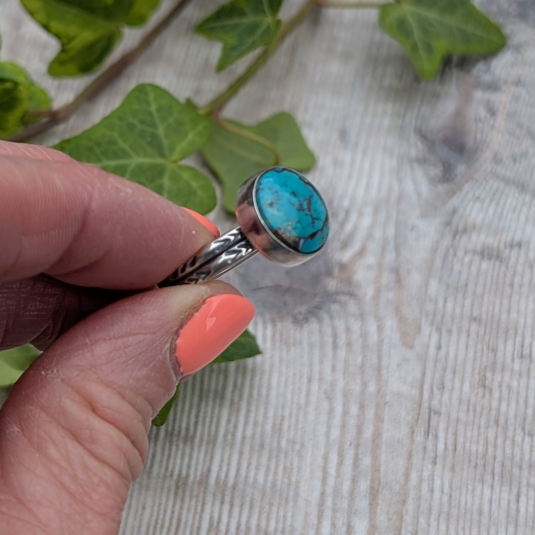 Side view of Silver Sunburst Stamped Ring with Turquoise showing bezel setting and chevron stamped band detail