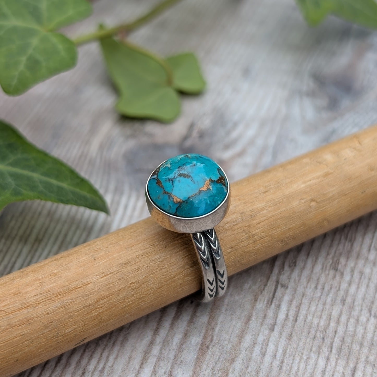 Close up of Silver Sunburst Stamped Ring with Turquoise highlighting blue Mohave Turquoise stone and matrix detail