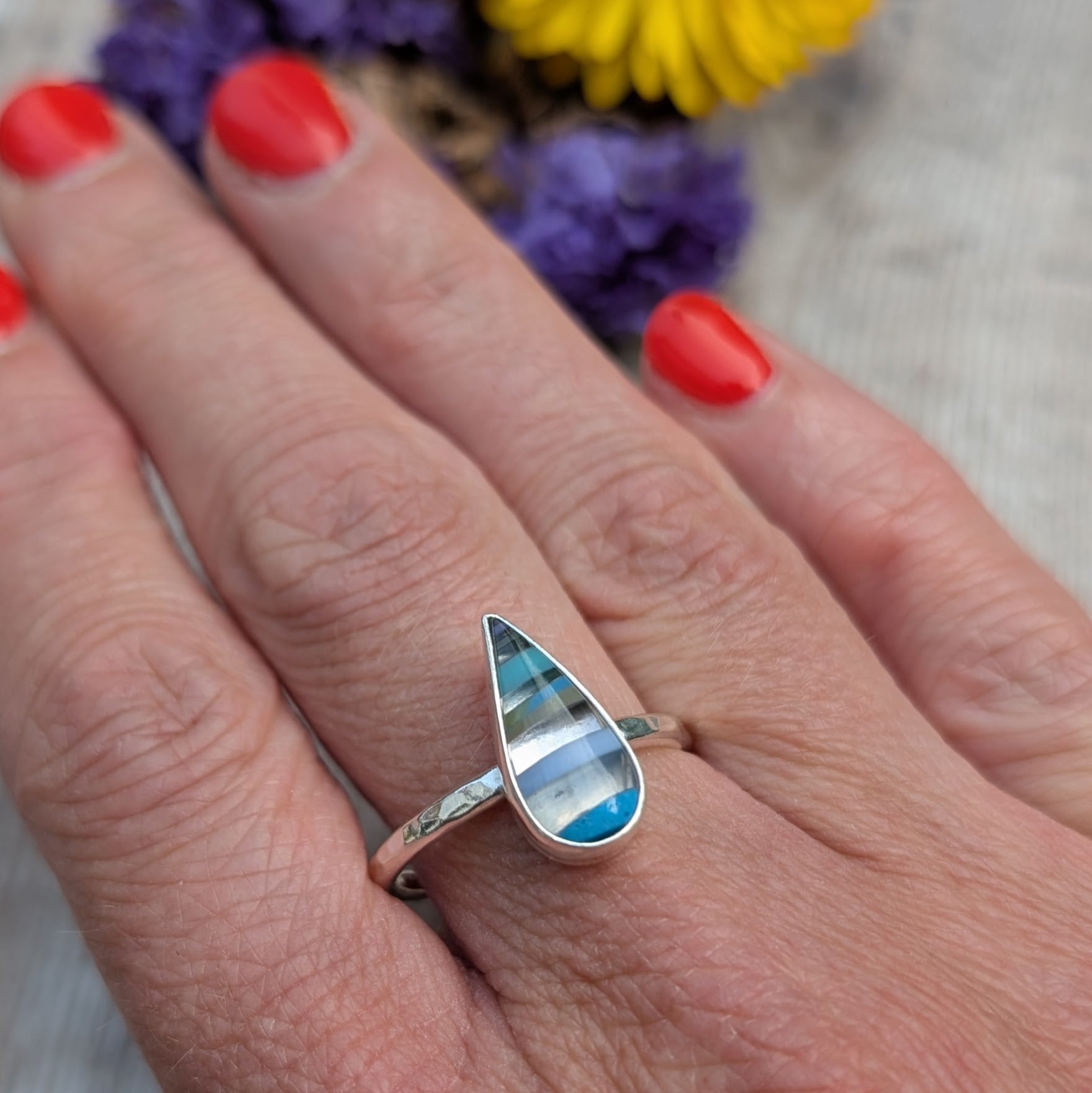 Recycled silver Surfite teardrop ring worn on hand, showing the size and hammered band detail.