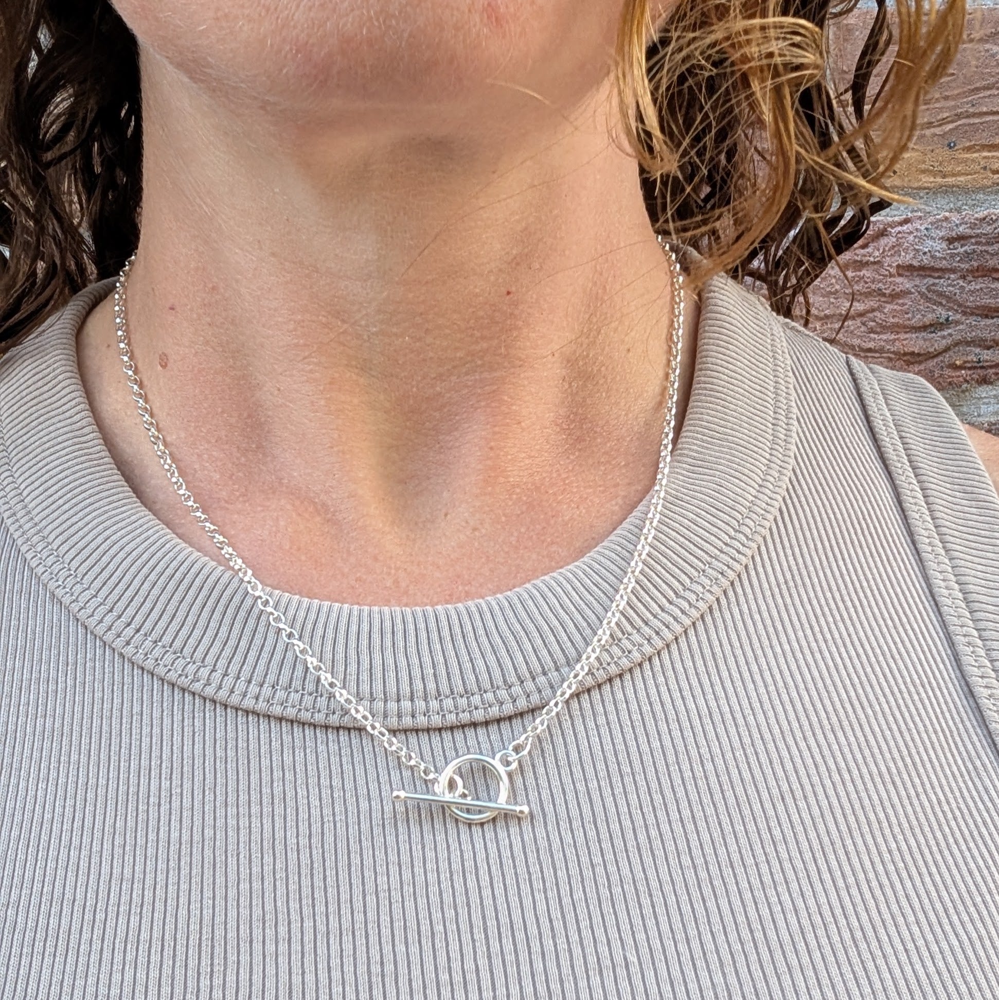 Silver T Bar Necklace handmade from recycled Sterling Silver, worn on a model with the T bar clasp sitting at the front of the necklace.