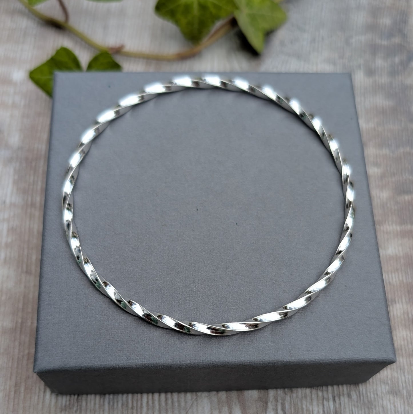Silver Twisted Round Bangle handmade from recycled Sterling Silver 2mm square wire, photographed from above to show the full round shape.