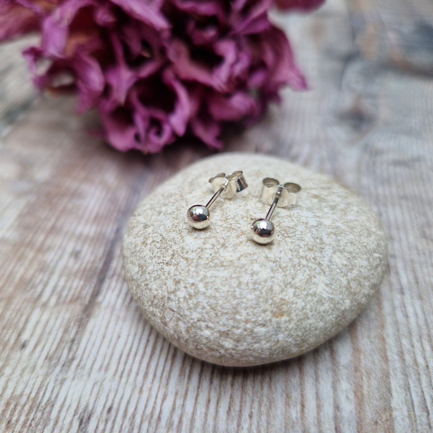 Sterling Silver pebble shape attached to silver earring bar.