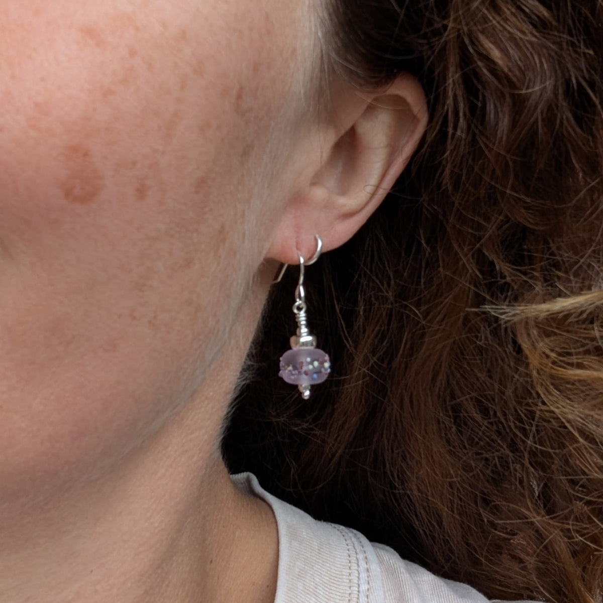 Tropical Pink Lampwork Glass Earrings being worn, showing the size and drop of the pink glass bead and recycled Sterling Silver earring.
