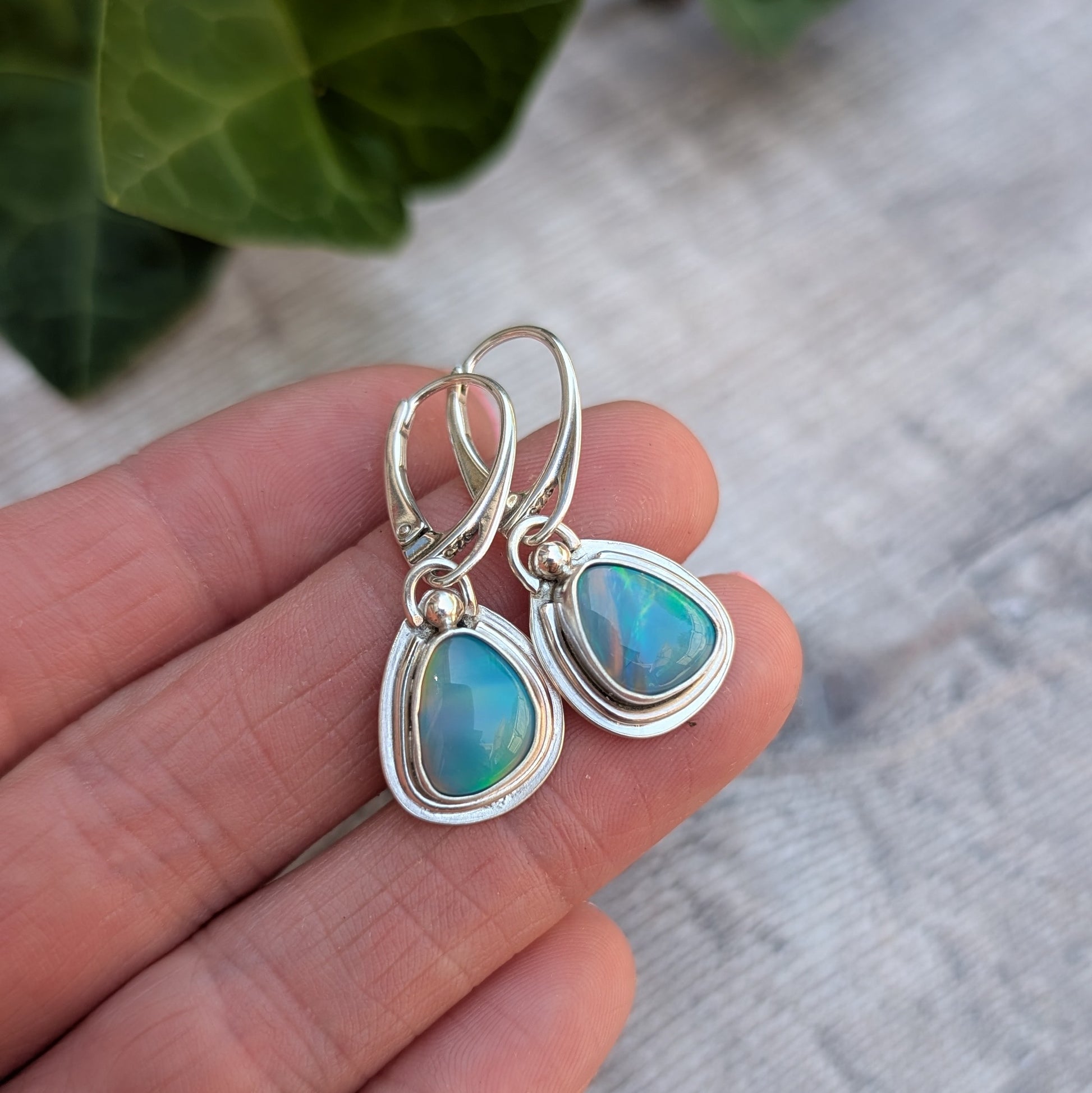 Turquoise Blue Aurora Opal Teardrop Earrings handmade from recycled Sterling Silver, shown close up with shimmering blue and green Aurora Opals.