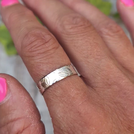 Video of Silver 5mm Leaf Patterned Ring worn on a finger, showing the textured hand stamped leaf pattern around the silver band.