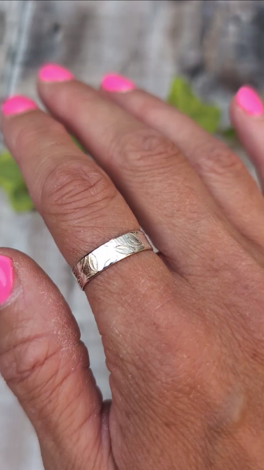 Video of Silver 5mm Leaf Patterned Ring worn on a finger, showing the textured hand stamped leaf pattern around the silver band.