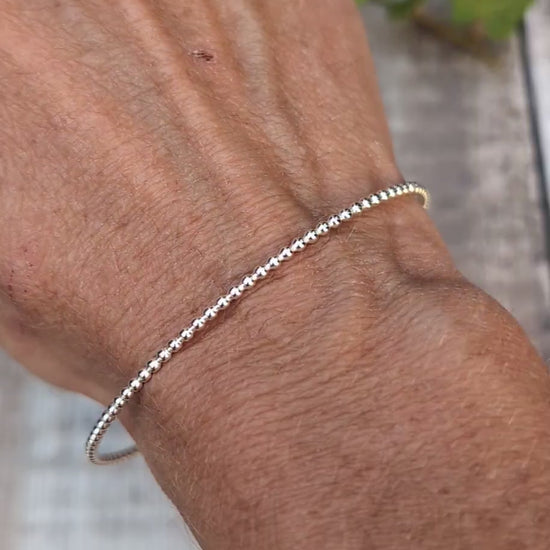 Video of Silver 2mm Beaded Round Bangle worn on the wrist, showing the simple round shape and beaded silver texture.