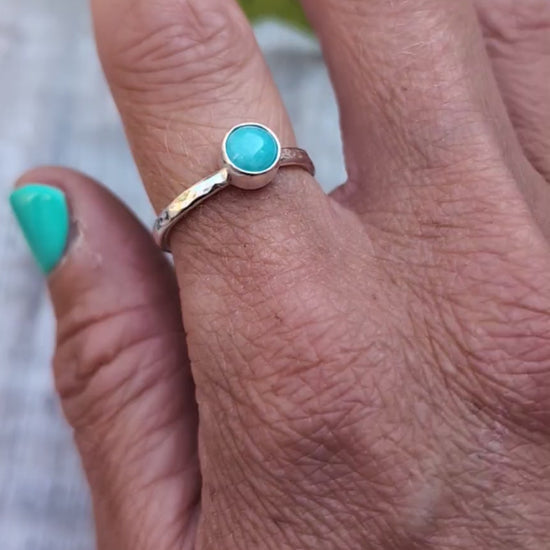 amazonite ring size R being worn on a hand, showing the handmade recycled Sterling Silver band with a round blue green Amazonite gemstone in a simple bezel setting.