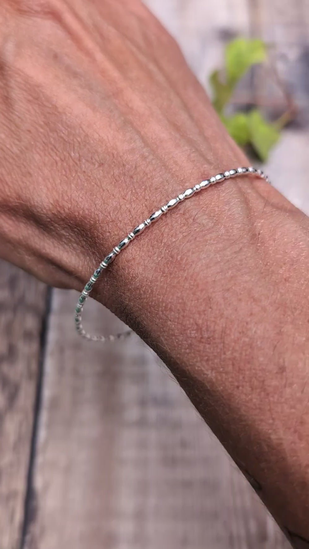 Video of Silver Oval Beaded Wire Round Bangle handmade from recycled Sterling Silver 2mm square wire, worn on the wrist to show the fit and delicate design.