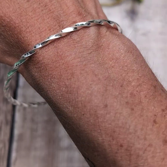 Video of Silver Twisted Round Bangle handmade from recycled Sterling Silver 2mm square wire, worn on the wrist to show the fit.