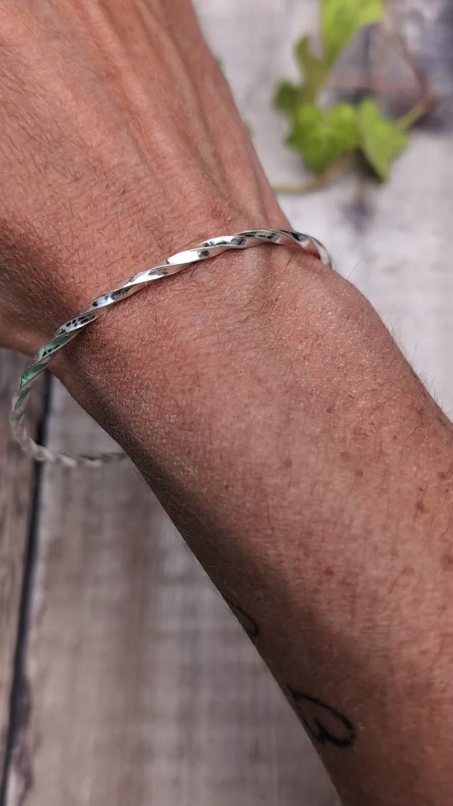 Video of Silver Twisted Round Bangle handmade from recycled Sterling Silver 2mm square wire, worn on the wrist to show the fit.
